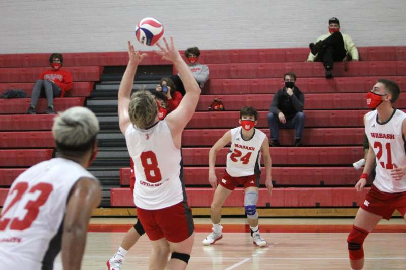 a group of people playing volleyball