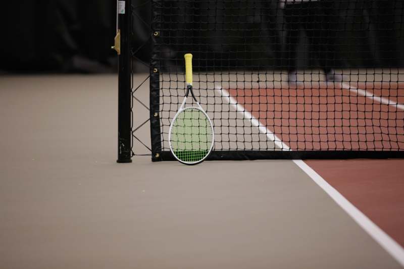 a tennis racket leaning against a net