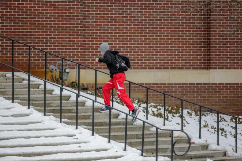 a person running up stairs in the snow
