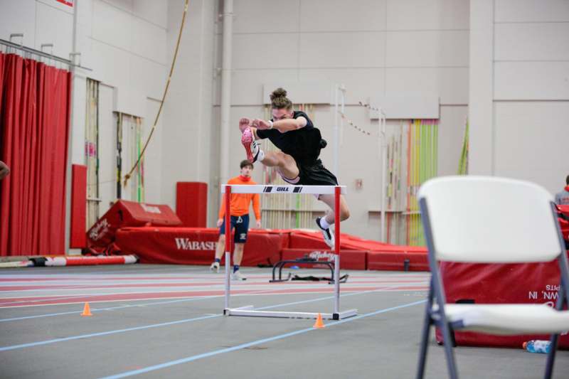 a person jumping over a hurdle