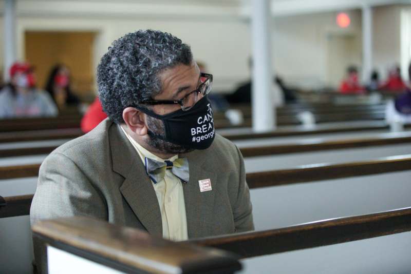 a man wearing a black mask with a white text on his face