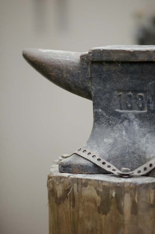 an anvil on a stump