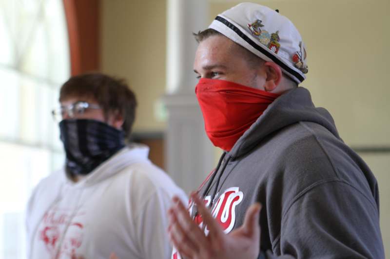 a man wearing a red face mask