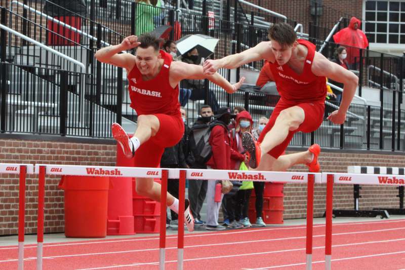 a group of men jumping over a hurdle