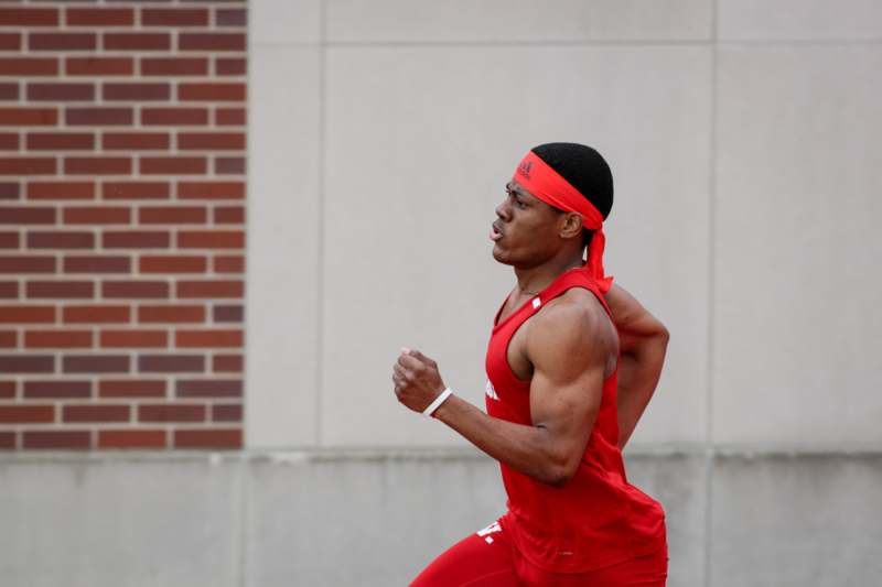 a man running in a red outfit