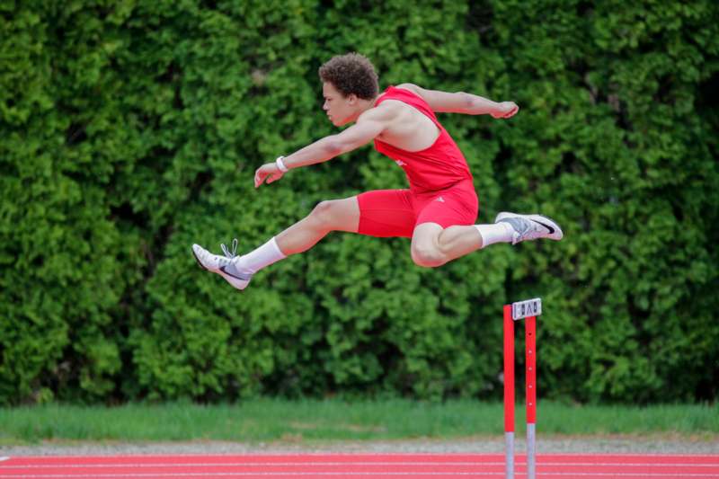 a man jumping over a hurdle