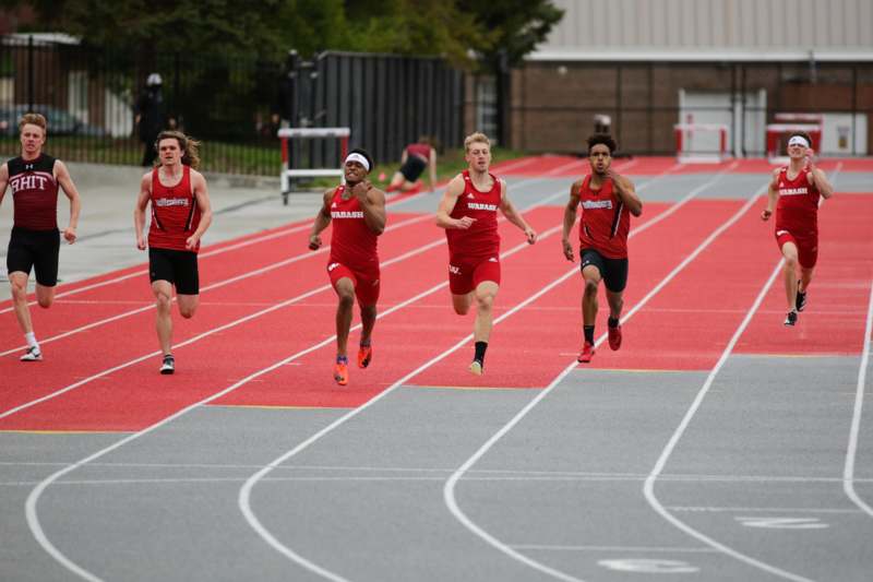 a group of men running on a track