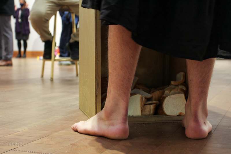 a person's bare feet on a wood floor
