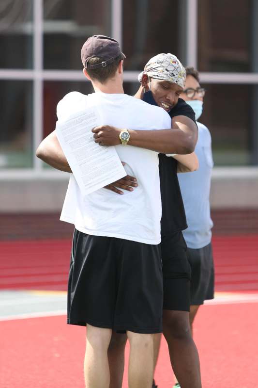 a man hugging another man