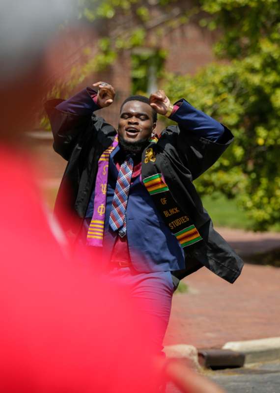 a man wearing a graduation cap and scarf