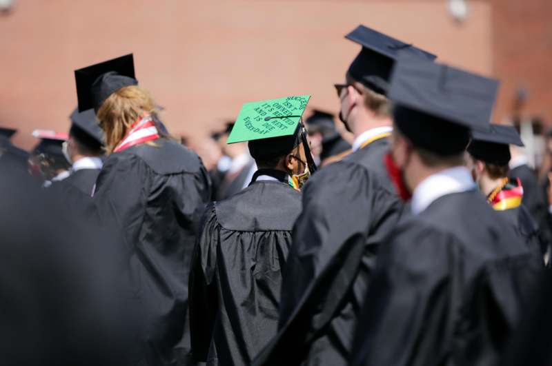 a group of people wearing graduation gowns and caps