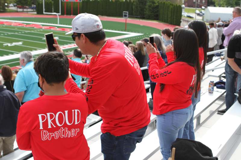 a group of people taking pictures of a football game