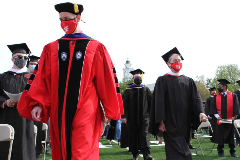 a group of people wearing caps and gowns