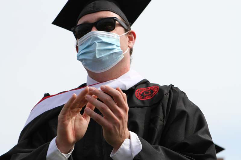 a man wearing a medical mask and cap and gown