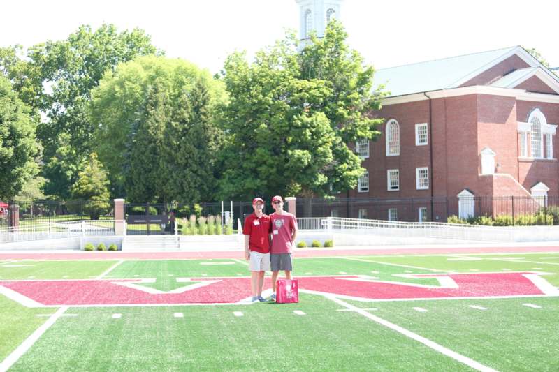 two men standing on a football field