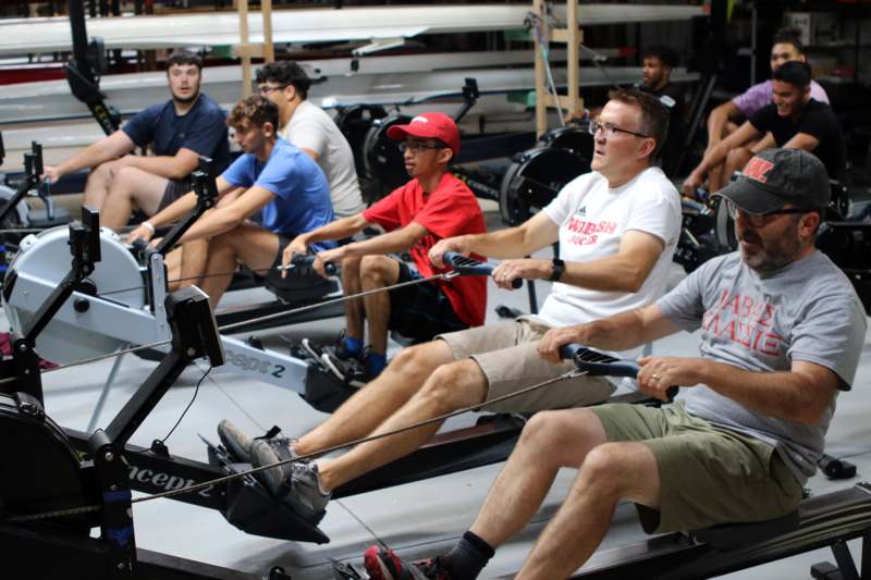 a group of people on rowing machines