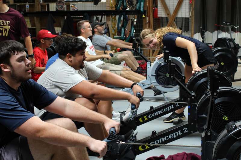 a group of people on exercise bikes