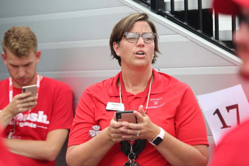 a woman in red shirt holding a phone