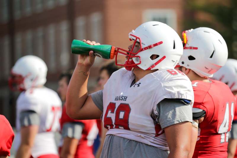 a football player drinking from a bottle