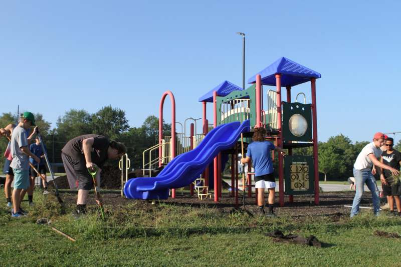 a man and woman playing at a playground