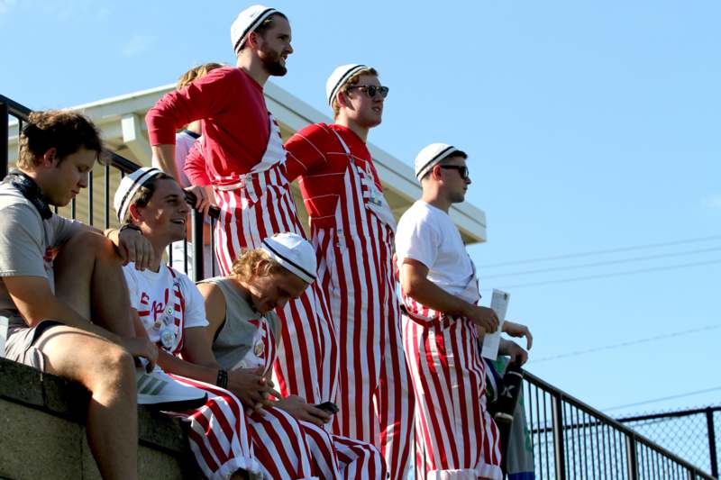a group of men wearing striped overalls
