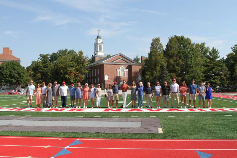 a group of people standing in a line on a football field