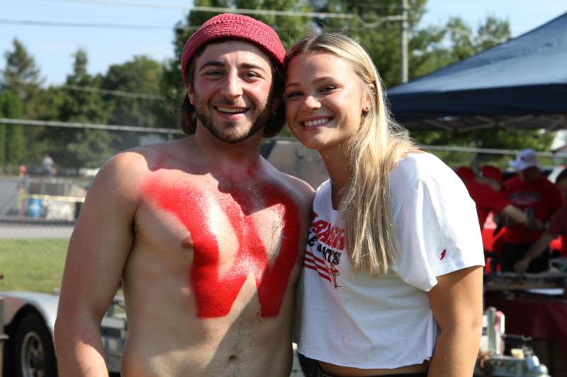 a man and woman with red paint on their chest
