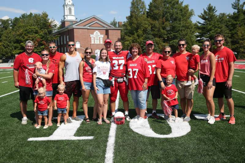 a group of people posing for a photo on a football field