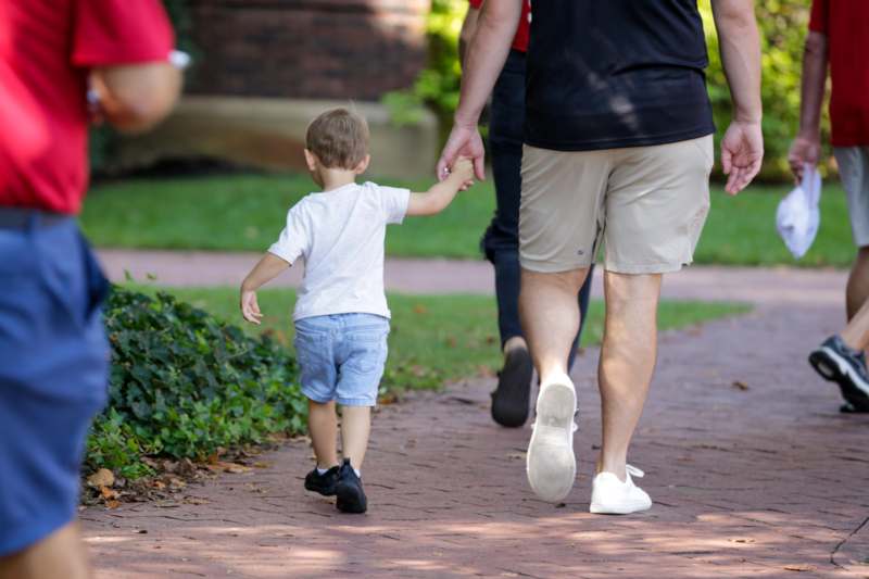 a man and child walking on a path