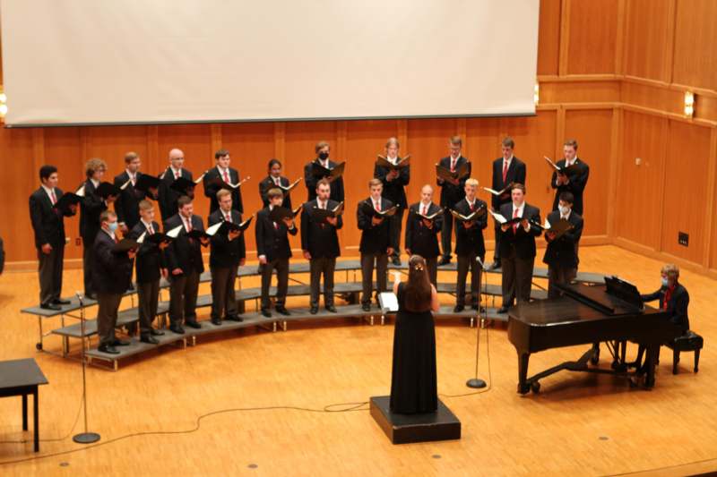 a group of people performing in a choir
