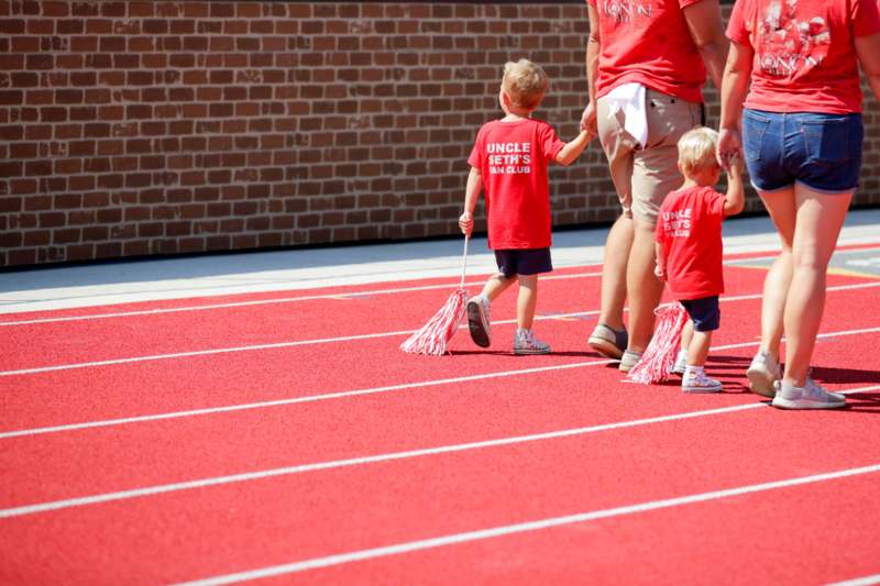a group of kids walking on a track