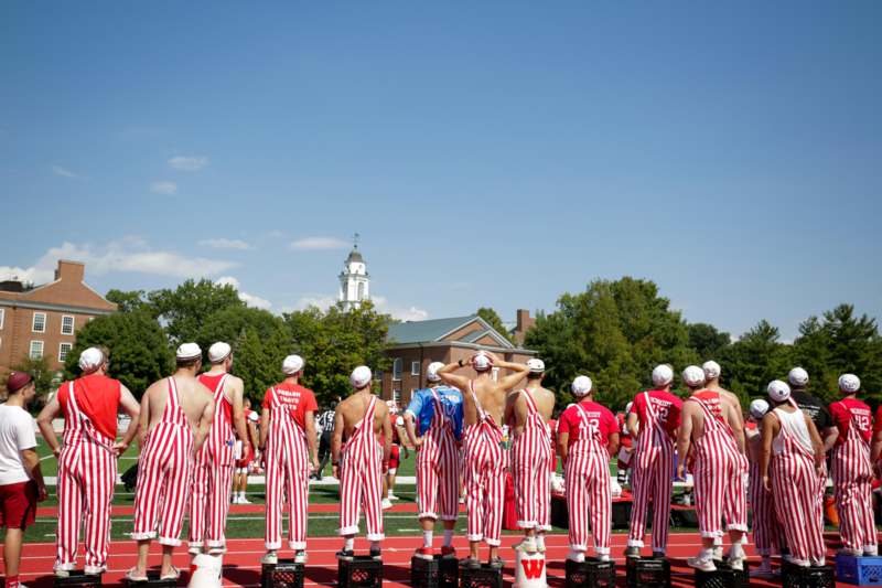 a group of people in striped overalls