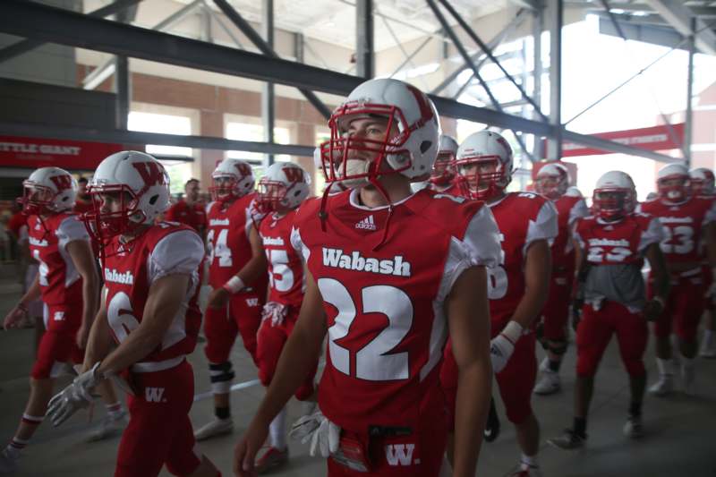 a group of football players in red uniforms