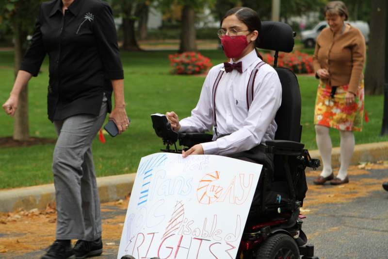 a person in a wheelchair with a sign