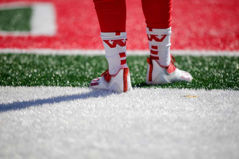a person's legs on a football field