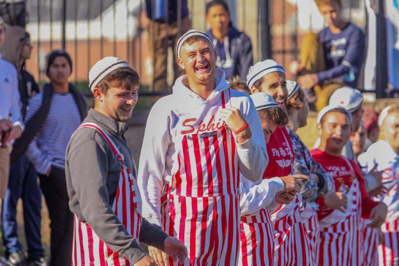 a group of people wearing striped overalls
