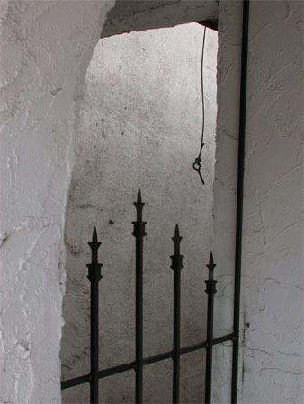 a metal gate with a rope from it