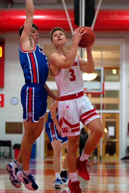 a basketball player in a uniform playing basketball