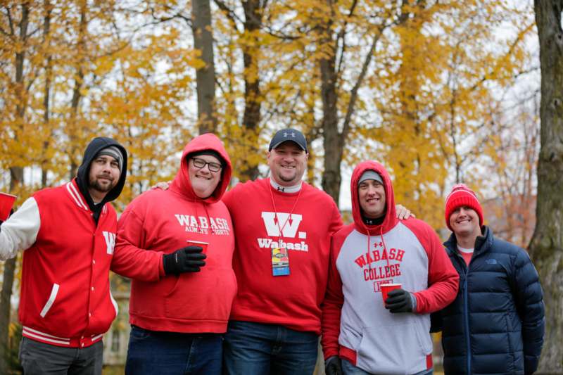 a group of men wearing red hoodies and hats