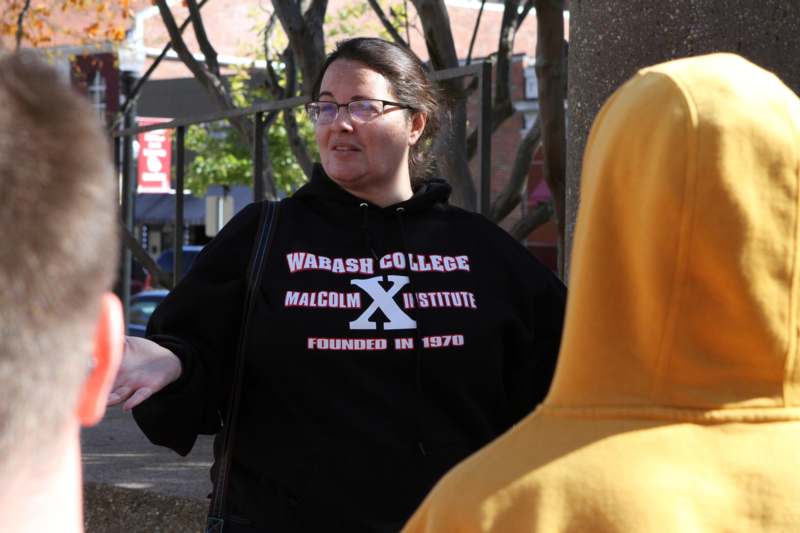 a woman wearing a black sweatshirt with white text