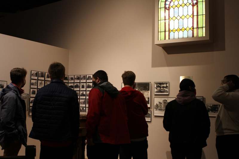 a group of people looking at a stained glass window