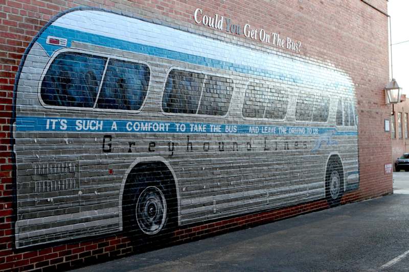 a brick wall with a bus painted on it