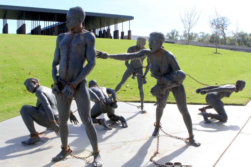 statues of men tied to chains