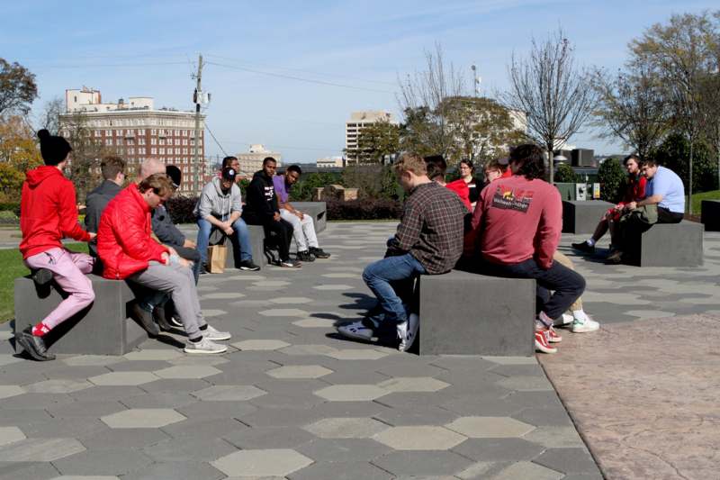 a group of people sitting on a stone block