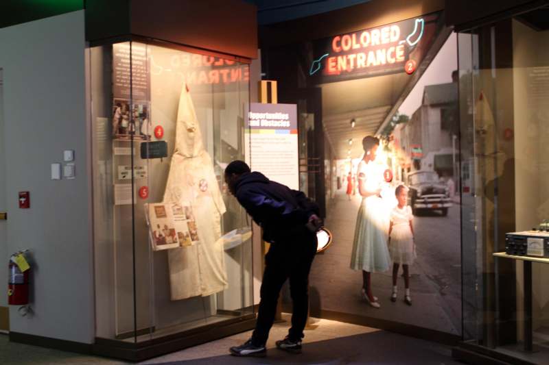a man looking at a display case