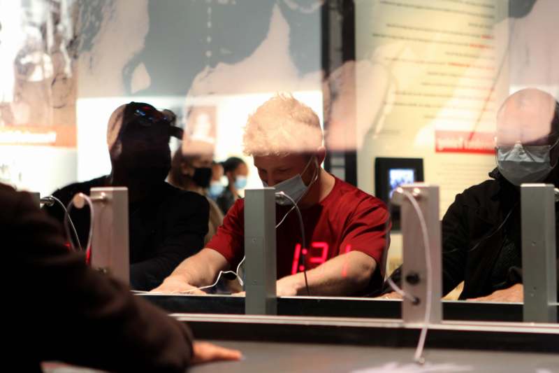 a man wearing a mask and looking at a screen