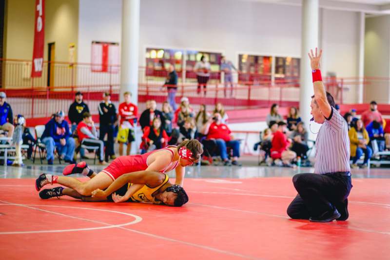 a man wrestling on the floor