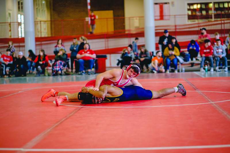 a man wrestling on a red floor