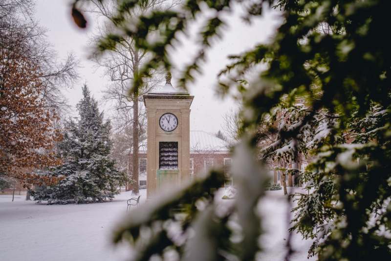 a clock tower in the snow