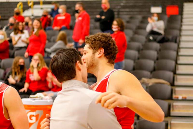 two men kissing in a gym